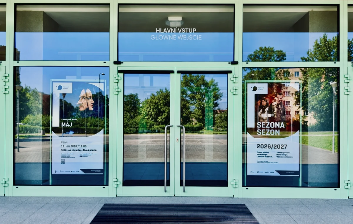 Two digital theatre posters beside the entrance to Těšín Theatre